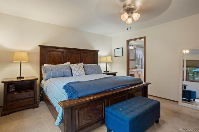 carpeted bedroom featuring connected bathroom and ceiling fan