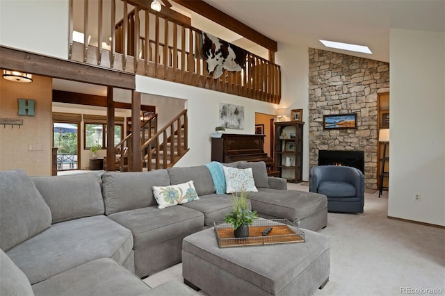 living room featuring beam ceiling, light colored carpet, a fireplace, and high vaulted ceiling