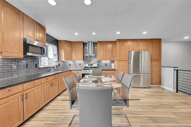 1922 Danube Way, Aurora, CO 80011 - kitchen featuring appliances with stainless steel finishes, wall chimney exhaust hood, decorative backsplash, recessed lighting, and wood tiled floors