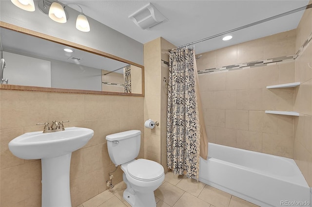 1922 Danube Way, Aurora, CO 80011 - full bathroom with tile patterned floors, tile walls, shower / bathtub combination with curtain, and recessed lighting