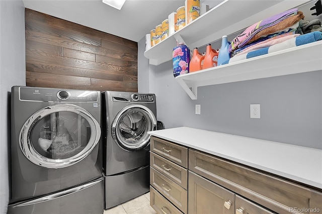 1922 Danube Way, Aurora, CO 80011 - washroom with washing machine and dryer, light tile patterned floors, and cabinet space