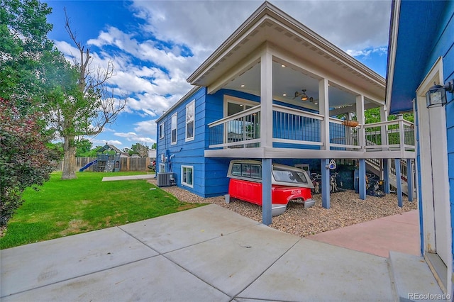 1922 Danube Way, Aurora, CO 80011 - view of side of property featuring a lawn and a central AC unit