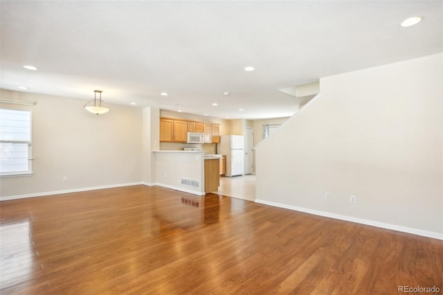 unfurnished living room featuring light hardwood / wood-style floors