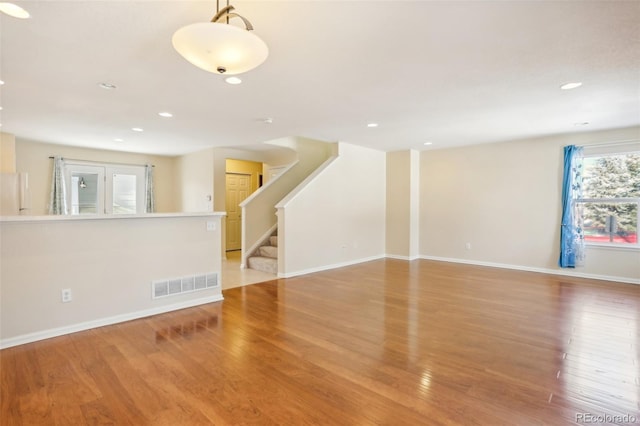 unfurnished living room featuring hardwood / wood-style flooring