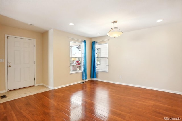 spare room with light hardwood / wood-style floors