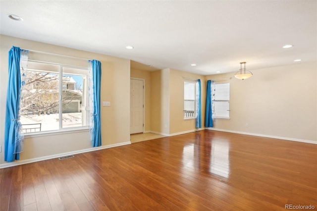 spare room with hardwood / wood-style floors