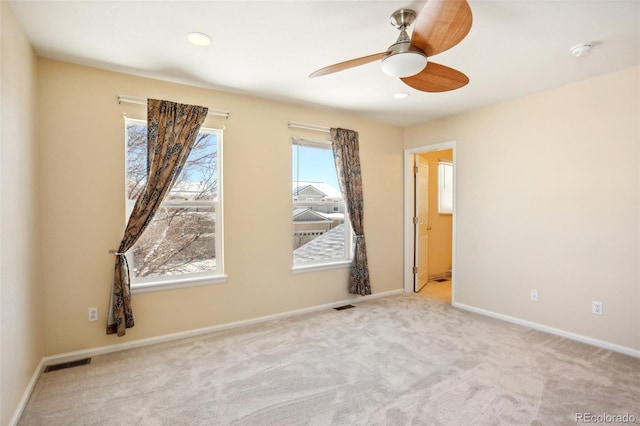 unfurnished room featuring ceiling fan and light colored carpet