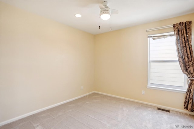 empty room with light colored carpet and ceiling fan