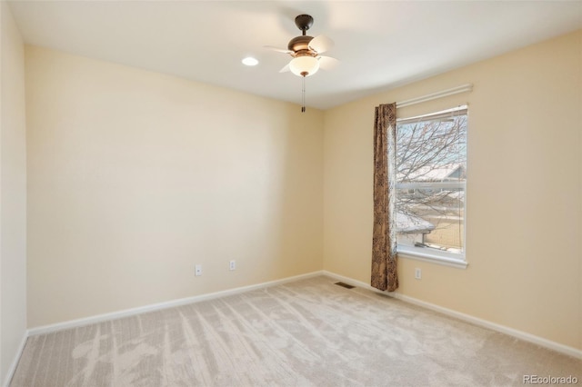 carpeted empty room featuring ceiling fan