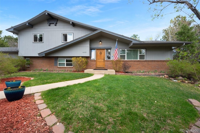 6535 Arequa Ridge Ln, Colorado Springs, CO 80919 - tri-level home with brick siding and a front yard