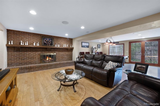 6535 Arequa Ridge Ln, Colorado Springs, CO 80919 - living area featuring recessed lighting, a brick fireplace, and wood finished floors