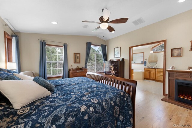 6535 Arequa Ridge Ln, Colorado Springs, CO 80919 - bedroom with recessed lighting, ensuite bathroom, vaulted ceiling, light wood-type flooring, and visible vents