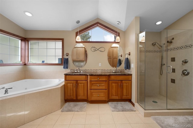 6535 Arequa Ridge Ln, Colorado Springs, CO 80919 - full bathroom featuring double vanity, a bath, tile patterned flooring, vaulted ceiling, and a stall shower