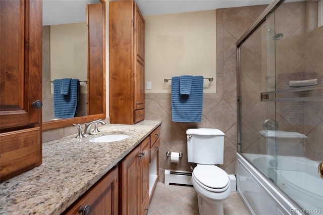 6535 Arequa Ridge Ln, Colorado Springs, CO 80919 - full bathroom featuring vanity, toilet, tile walls, a baseboard heating unit, and enclosed tub / shower combo