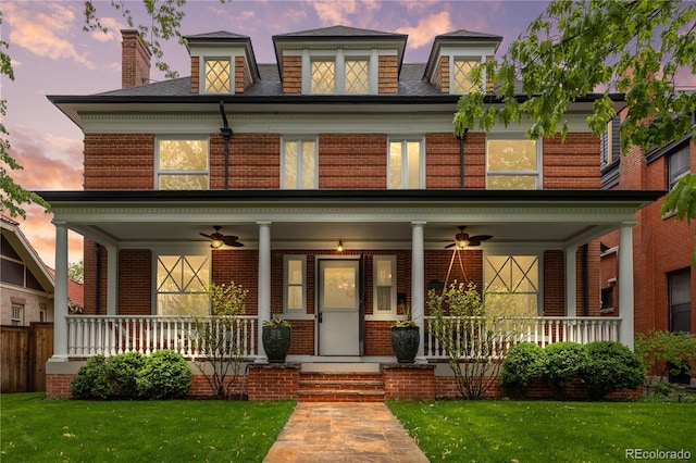 963 N Lafayette St, Denver, CO 80218 - view of front of property with ceiling fan, a front lawn, and brick siding