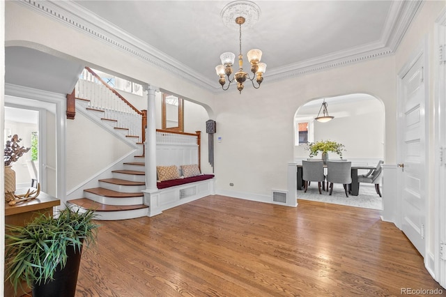 963 N Lafayette St, Denver, CO 80218 - unfurnished dining area featuring arched walkways, crown molding, stairway, wood finished floors, and healthy amount of natural light