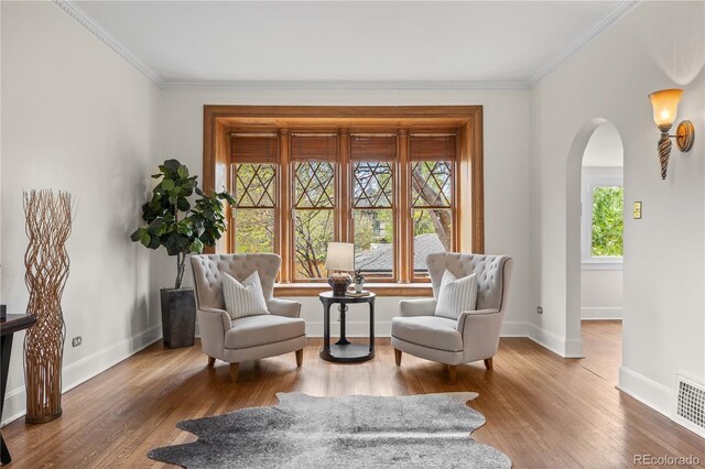 963 N Lafayette St, Denver, CO 80218 - sitting room with plenty of natural light, arched walkways, crown molding, baseboards, and wood finished floors