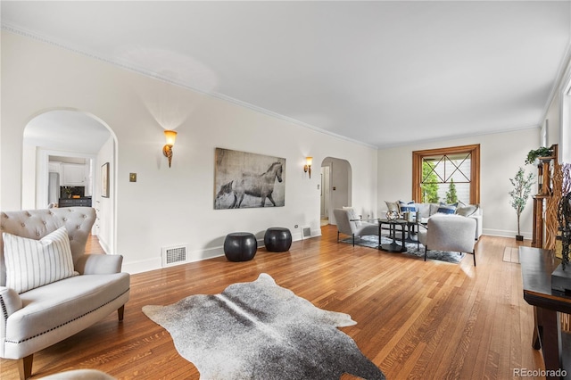 963 N Lafayette St, Denver, CO 80218 - living area with arched walkways, wood finished floors, ornamental molding, and baseboards