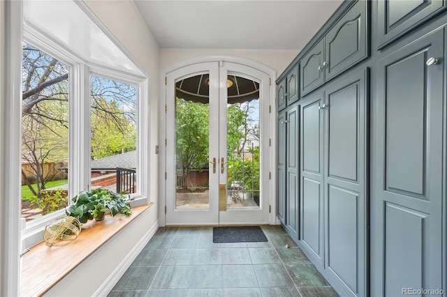 963 N Lafayette St, Denver, CO 80218 - doorway featuring french doors, arched walkways, dark tile patterned flooring, and baseboards