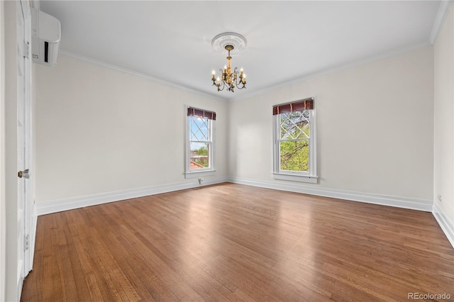 963 N Lafayette St, Denver, CO 80218 - empty room with a chandelier, wood finished floors, crown molding, and baseboards