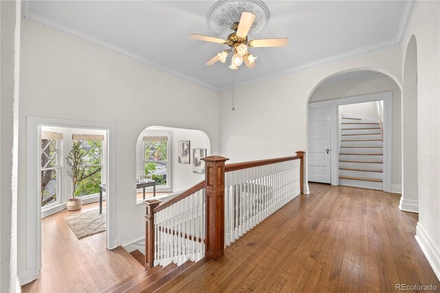 963 N Lafayette St, Denver, CO 80218 - hallway featuring hardwood / wood-style floors, an upstairs landing, baseboards, crown molding, and arched walkways