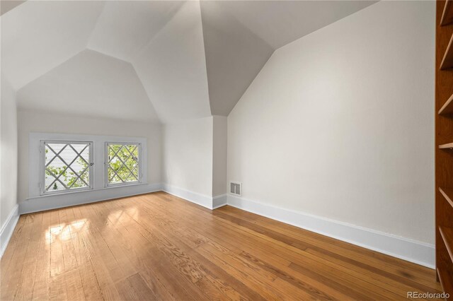 963 N Lafayette St, Denver, CO 80218 - additional living space with vaulted ceiling, baseboards, and hardwood / wood-style flooring