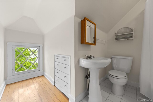963 N Lafayette St, Denver, CO 80218 - bathroom with lofted ceiling, toilet, baseboards, and a sink