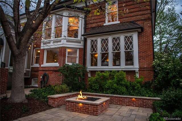 963 N Lafayette St, Denver, CO 80218 - rear view of property featuring a fire pit, brick siding, and a patio