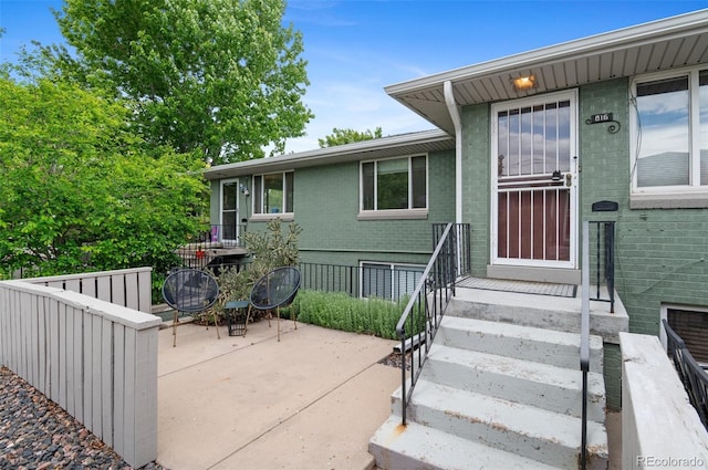 816 Forest St, Denver, CO 80220 - entrance to property featuring brick siding and a patio