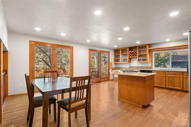 kitchen with plenty of natural light, a center island, and light hardwood / wood-style flooring