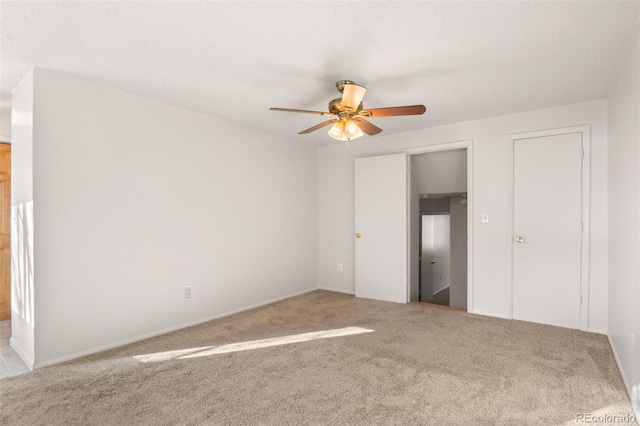 unfurnished bedroom featuring carpet and ceiling fan