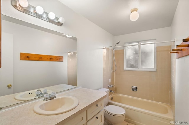 full bathroom featuring vanity, toilet, and tiled shower / bath