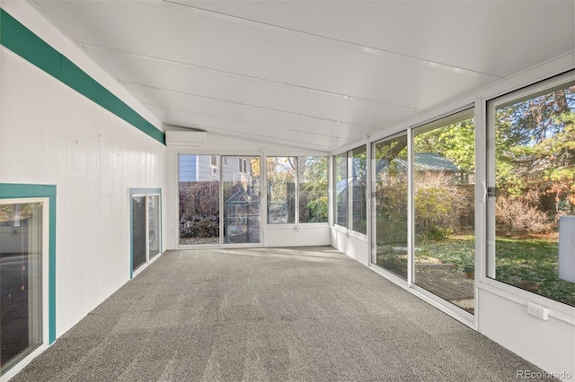 unfurnished sunroom with a wall mounted AC, a healthy amount of sunlight, and lofted ceiling