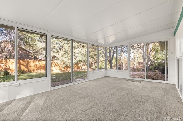 unfurnished sunroom featuring lofted ceiling