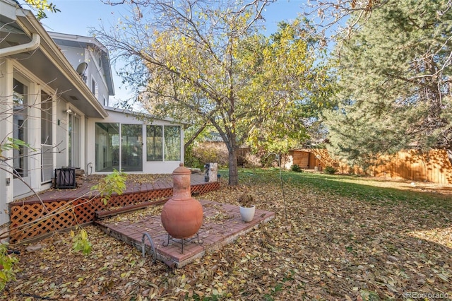 view of yard featuring a sunroom and a deck