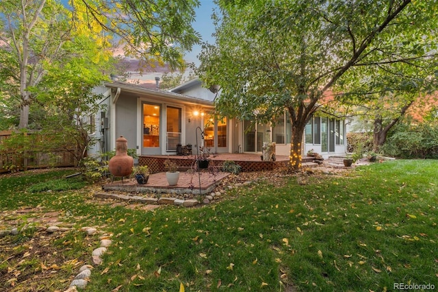 rear view of house with a yard and a patio