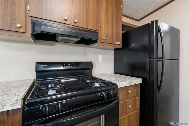 kitchen featuring black appliances, ornamental molding, and a textured ceiling