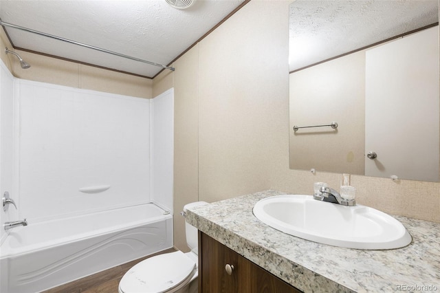 full bathroom featuring a textured ceiling, vanity, shower / bathtub combination, and toilet