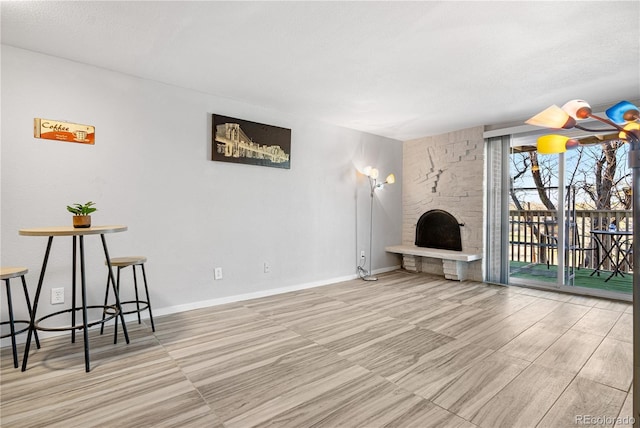 1304 S Parker Rd Unit 359, Denver, CO 80231 - unfurnished living room with a large fireplace and baseboards