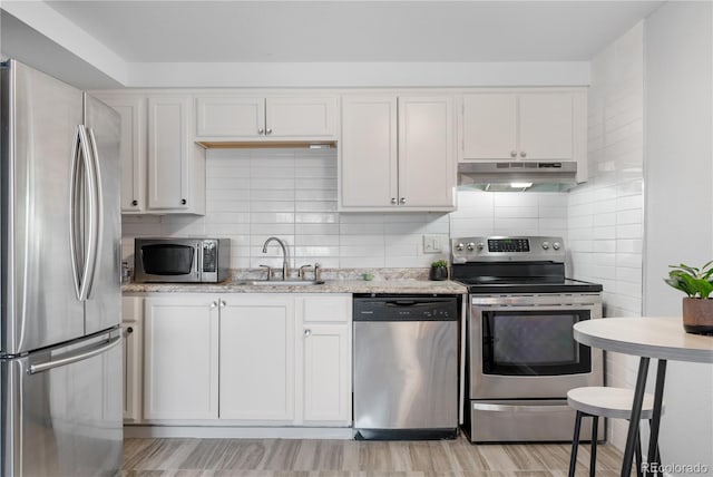 1304 S Parker Rd Unit 359, Denver, CO 80231 - kitchen with stainless steel appliances, under cabinet range hood, white cabinets, and tasteful backsplash