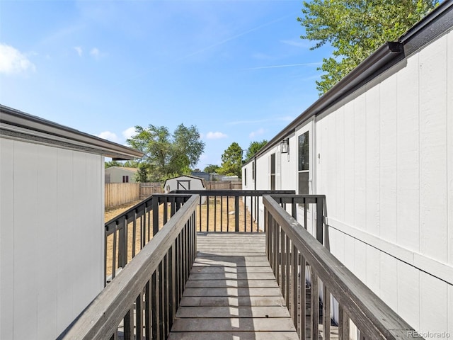 wooden terrace featuring a storage unit