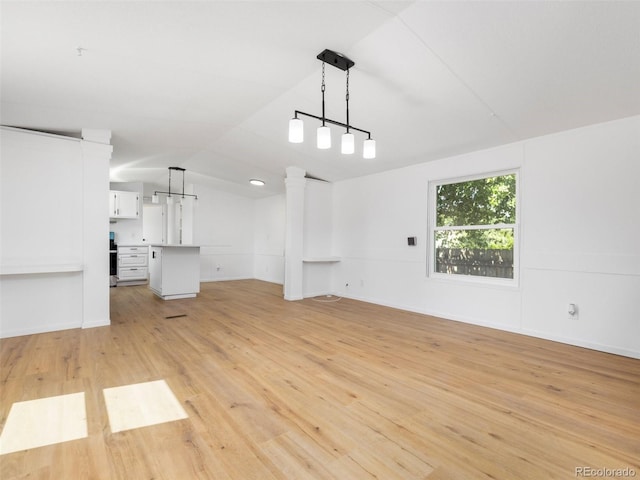 unfurnished living room with light hardwood / wood-style flooring and lofted ceiling