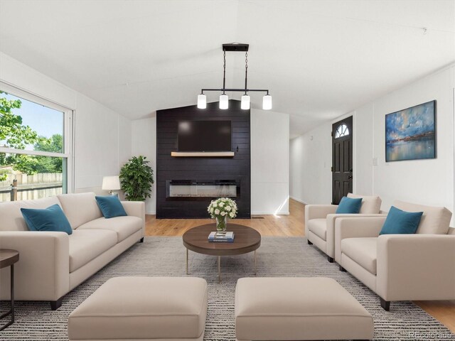 living room featuring light hardwood / wood-style flooring and a large fireplace