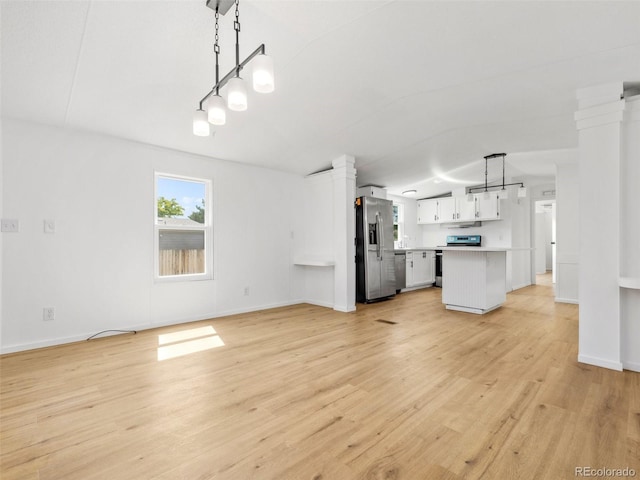 unfurnished living room featuring ornate columns and light wood-type flooring