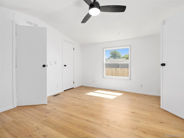 unfurnished bedroom with ceiling fan, light hardwood / wood-style flooring, and lofted ceiling