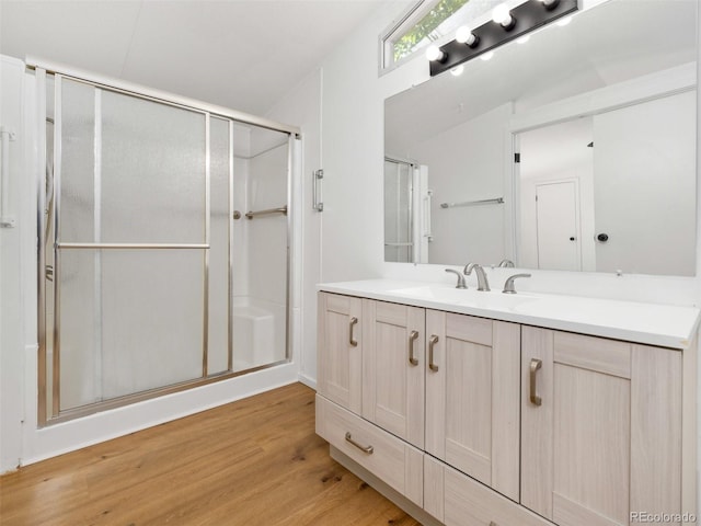 bathroom featuring vanity, lofted ceiling, an enclosed shower, and wood-type flooring