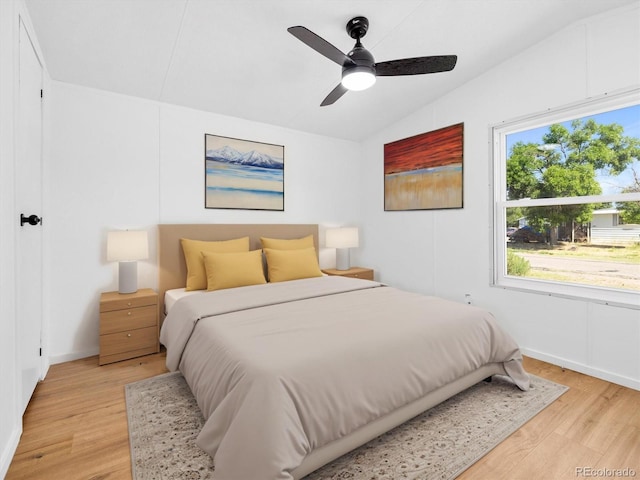 bedroom featuring ceiling fan, lofted ceiling, and light wood-type flooring