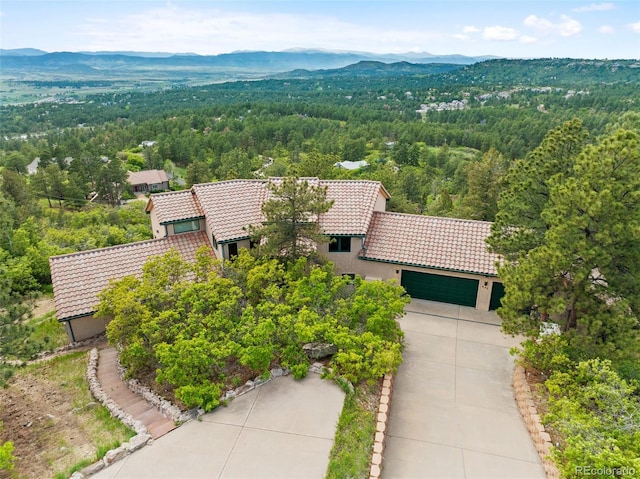 857 Pawnee Trl, Castle Rock, CO 80108 - view of subject property with a mountain backdrop and a heavily wooded area