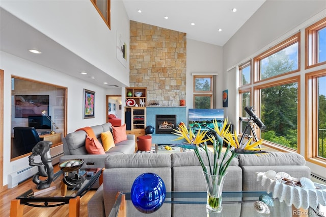 857 Pawnee Trl, Castle Rock, CO 80108 - living area with high vaulted ceiling, wood finished floors, recessed lighting, a fireplace, and a baseboard radiator