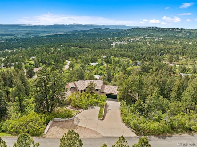 857 Pawnee Trl, Castle Rock, CO 80108 - aerial view of property and surrounding area featuring a heavily wooded area and a mountain backdrop
